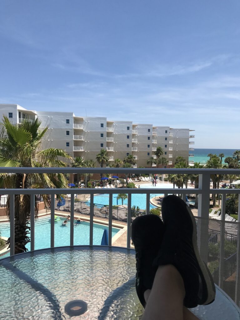 kicked back feet in from of tropical resort